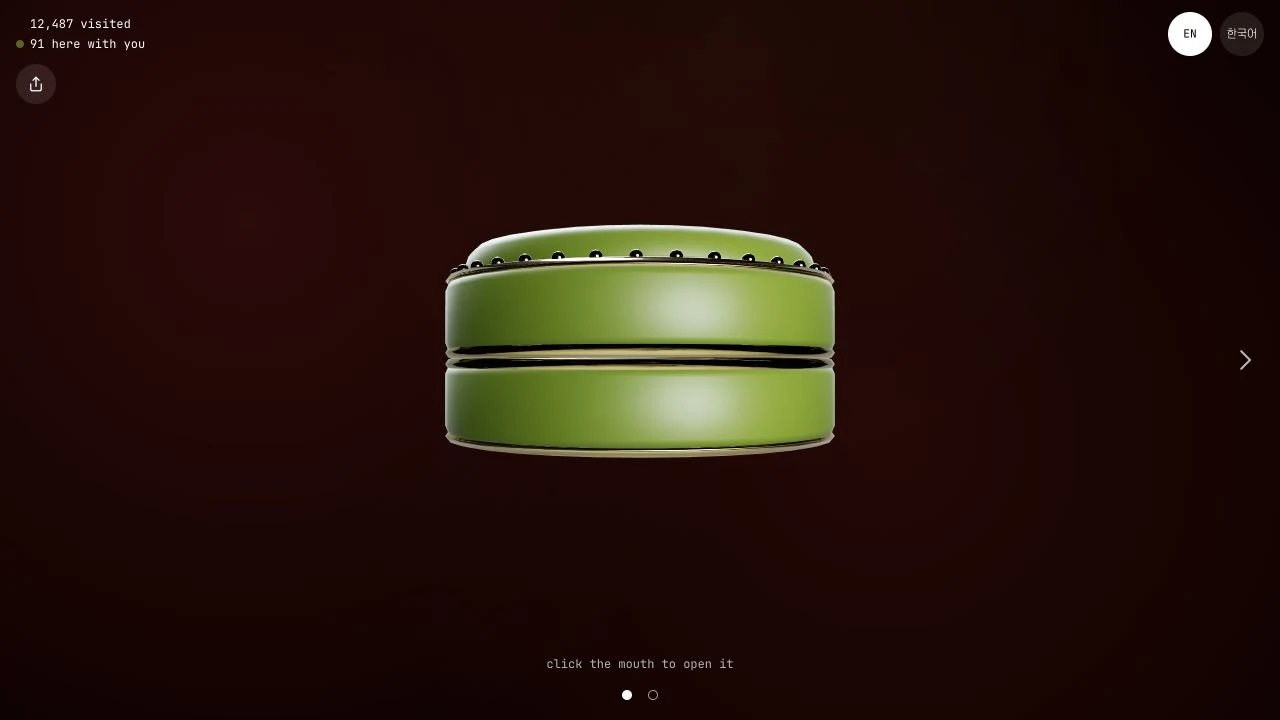 Closed green mouth with EN and Korean language buttons and click-to-open instruction